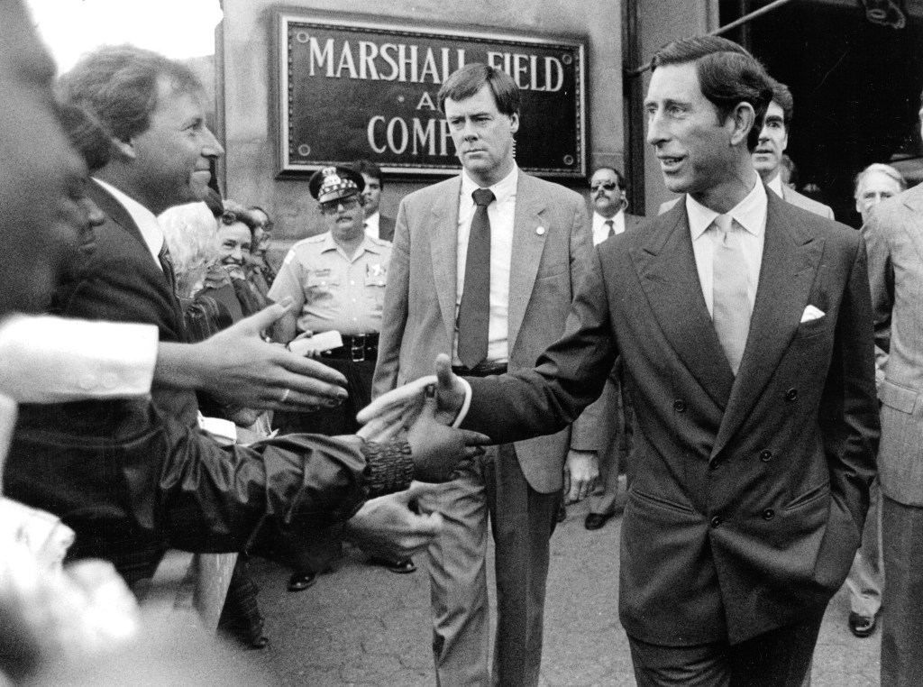 Prince (now King) Charles tours the city — and takes a tumble on the polo field
