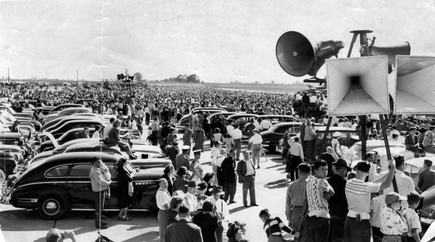 A huge crowd, estimated at 200,000 people, gathers behind the reviewing stand (right) watching an air show staged by U.S. Navy planes as the city's newly dubbed O'Hare International Airport is dedicated on Sept. 18, 1949. (Chicago Tribune historical photo)