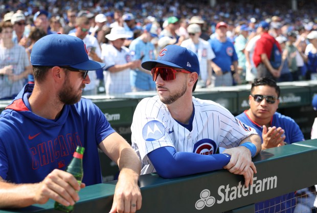Chicago Cubs outfielder Kyle Tucker, center, watches the game from the dugout Wednesday, Aug. 6, 2025, at Wrigley Field. (Brian Cassella/Chicago Tribune)
