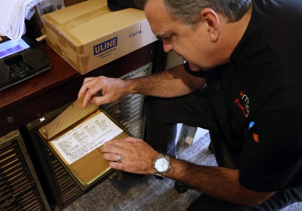 Regional chef Brad Saylor looks through an historic recipe card catalog at The Walnut Room inside Macy's in Chicago on Sept. 9, 2025. (Terrence Antonio James/Chicago Tribune)