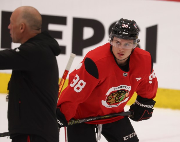 Center Connor Bedard (98) looks at coach Jeff Blashill during practice Thursday, Sept. 18, 2025, as the Chicago Blackhawks begin training camp at Fifth Third Arena. (Brian Cassella/Chicago Tribune)