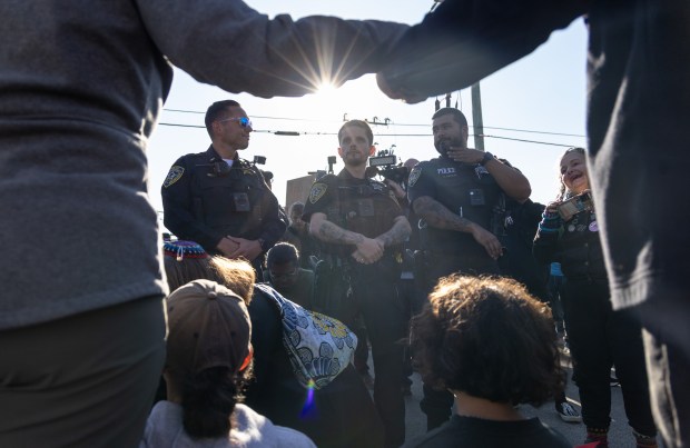 Broadview police watch and ask protestors to move as protesters...
