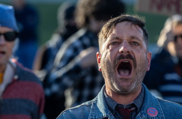 A protester, who declined to be named, leads others in...
