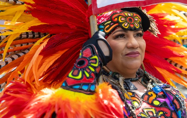 Aztec dancers prepare to march in the annual 26th Street...