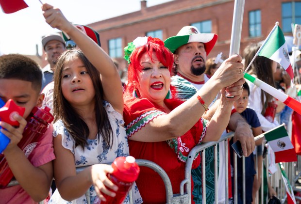 People watch and cheer during the annual 26th Street Mexican Independence Day Parade on Sept. 14, 2025, in Chicago's Little Village neighborhood. (Brian Cassella/Chicago Tribune)