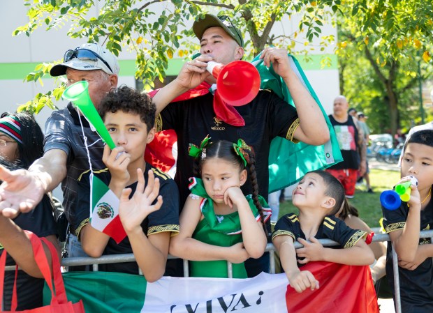 People watch and cheer during the annual 26th Street Mexican...