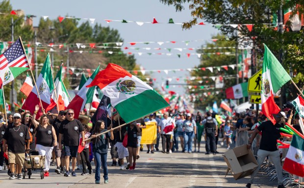 Participants march in the annual 26th Street Mexican Independence Day...