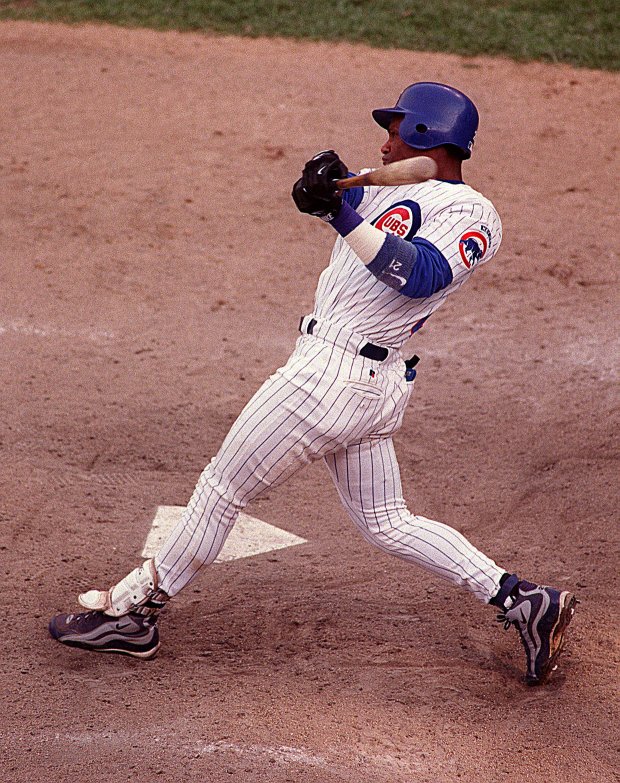 Chicago Cubs slugger Sammy Sosa watches his 62nd home run sail over the left field fence on Sept. 13, 1998 at Wrigley Field during the Cubs' 11-10 victory over the Milwaukee Brewers. (Jim Prisching/Chicago Tribune)