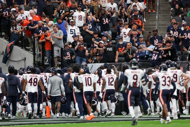 Chicago Bears fans cheer as the Bears run to the...