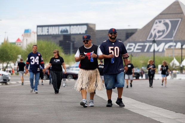 From left, Roy Barragan and Javier Salas walk outside before the Chicago Bears play the Las Vegas Raiders at Allegiant Stadium, Sept. 28, 2025, in Las Vegas. (Armando L. Sanchez/Chicago Tribune)