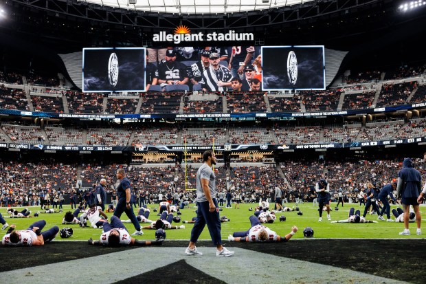 Bears players warm up before playing the Raiders at Allegiant...