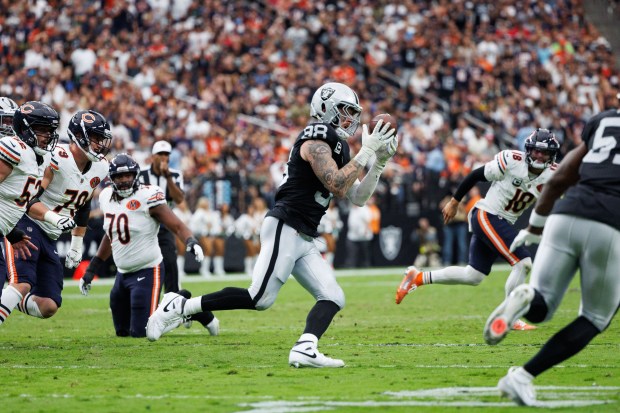 Las Vegas Raiders defensive end Maxx Crosby (98) gets an...