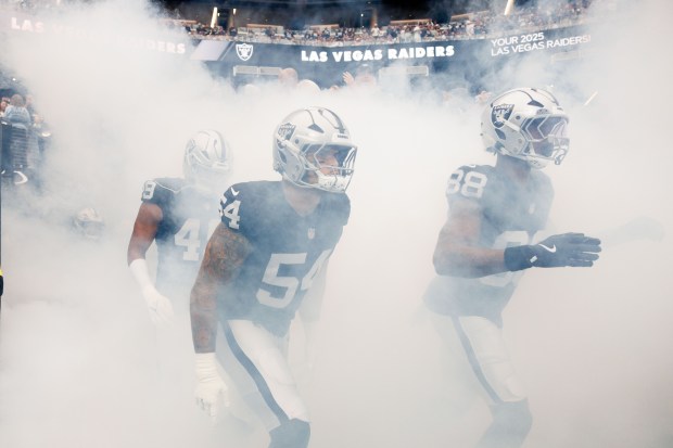 Las Vegas Raiders players take the field before playing the...