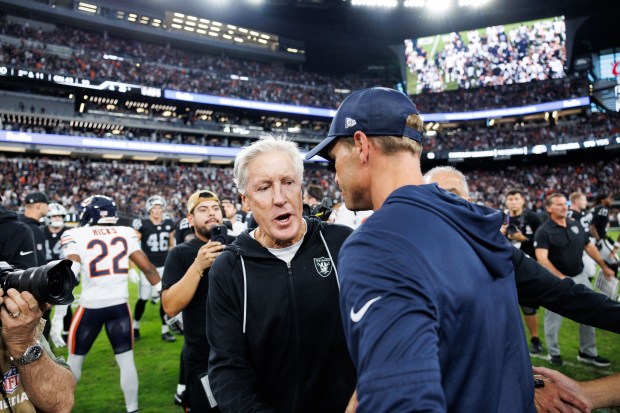 Chicago Bears head coach Ben Johnson talks with Las Vegas...