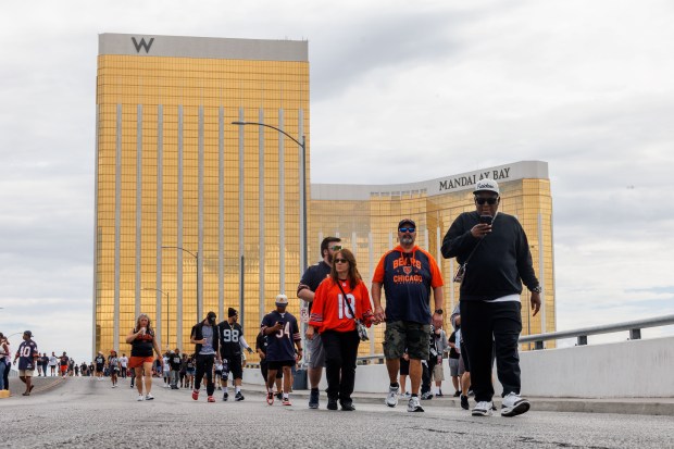 Chicago Bears and Las Vegas Raiders fans walk near the Mandalay Bay Hotel before the Chicago Bears play the Las Vegas Raiders at Allegiant Stadium Sunday Sept. 28, 2025, in Las Vegas. (Armando L. Sanchez/Chicago Tribune)