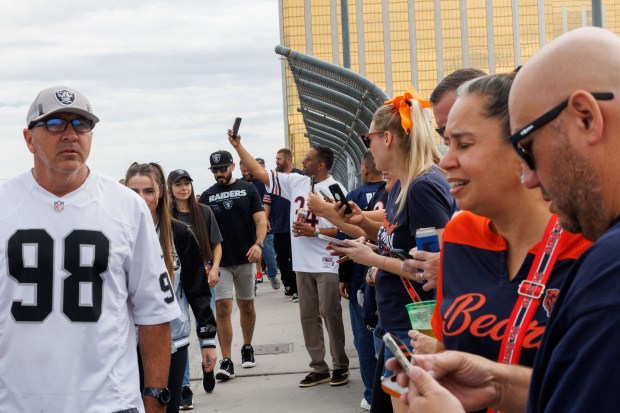 Chicago Bears and Las Vegas Raiders rans take selfies on a bridge before the Chicago Bears play the Las Vegas Raiders at Allegiant Stadium, Sept. 28, 2025, in Las Vegas. (Armando L. Sanchez/Chicago Tribune)