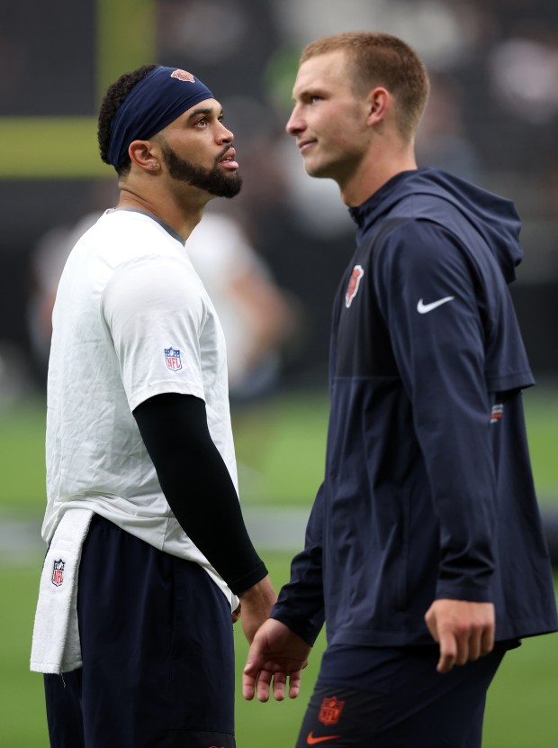 Chicago Bears quarterbacks Caleb Williams (left) and Tyson Bagent warm...
