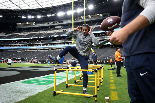 Chicago Bears wide receiver Rome Odunze warms up for a...