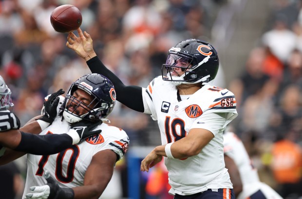 Chicago Bears quarterback Caleb Williams (18) makes a pass in...