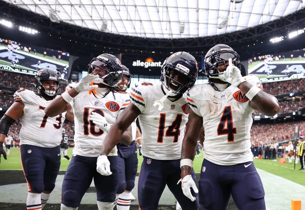 Chicago Bears running back d'Andre Swift (4) celebrates after scoring...