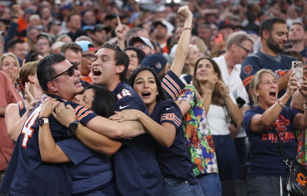 Chicago Bears fans celebrate in the stands after a blocked...