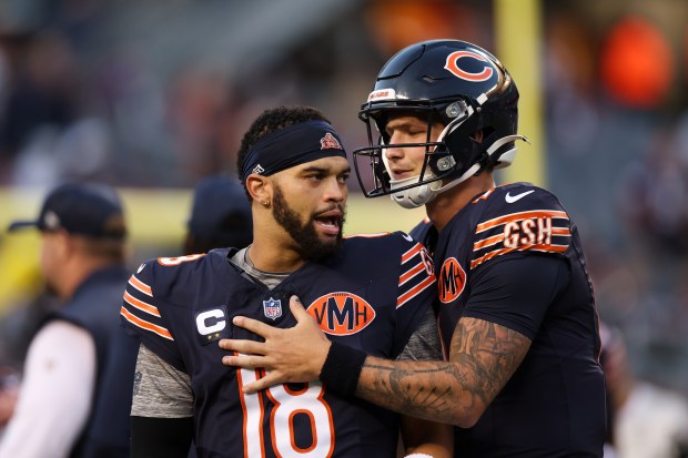 Chicago Bears quarterback Tyson Bagent (17) talks with Chicago Bears quarterback Caleb Williams (18) before the Bears play the Minnesota Vikings at Soldier Field on Sept. 8, 2025, in Chicago. (Armando L. Sanchez/Chicago Tribune)