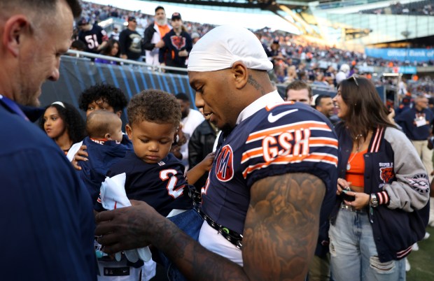 Chicago Bears wide receiver DJ Moore says hello to his young son before a game against the Minnesota Vikings at Soldier Field in Chicago on Sept. 8, 2025. (Chris Sweda/Chicago Tribune)