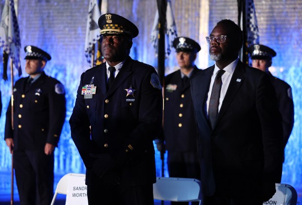 Chicago Police Department Superintendent Larry Snelling (front/left) and Chicago mayor Brandon Johnson (front/right) attend the Chicago Police Memorial Foundation's annual candlelight vigil at the Gold Star Families Memorial on Sept. 10, 2025. (Chris Sweda/Chicago Tribune)