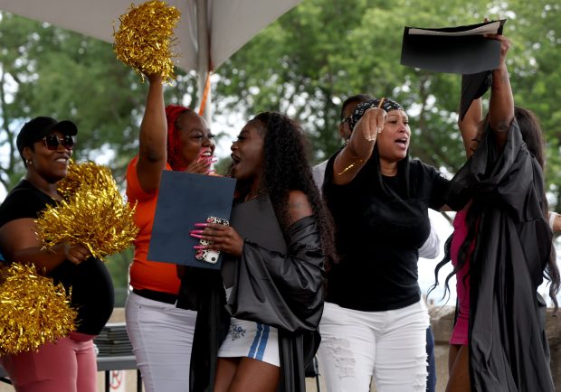 CRED graduates are congratulated by staff members at the South Shore Cultural Center in Chicago on Aug. 21, 2025. Chicago CRED held its ninth annual high school graduation for participants in the community violence intervention program. (Antonio Perez/Chicago Tribune)