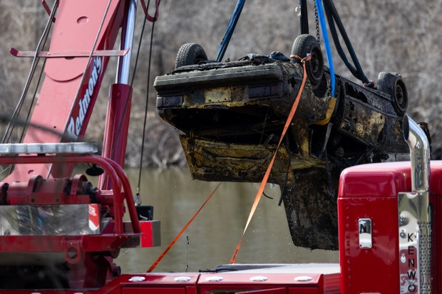 A crane raises the car belonging to Karen Schepers from...