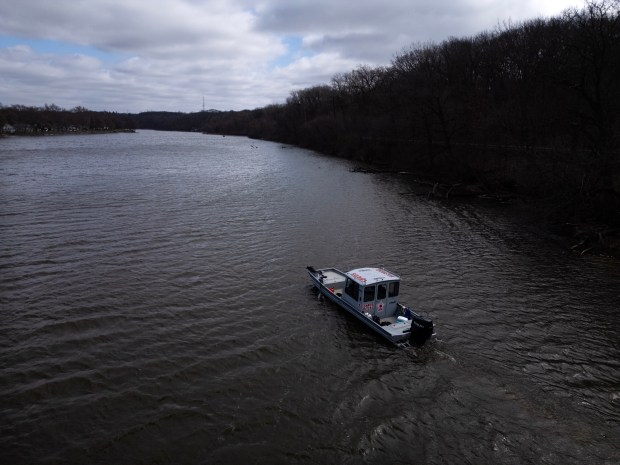 Elgin Police Department members and Chaos Divers use sonar to...