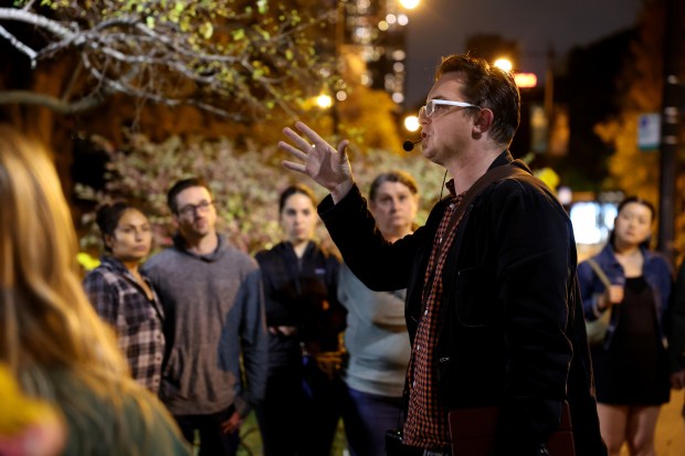 A tour listens as Adam Selzer delivers a talk about the haunted history of Lincoln Park Zoo on Oct. 22, 2024. (Chris Sweda/Chicago Tribune)