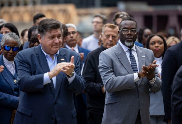 Gov. JB Pritzker and Mayor Brandon Johnson applaud speakers as city, state and federal leaders denounced President Donald Trump's possible military deployment into the city, Aug. 25, 2025. (Brian Cassella/Chicago Tribune)