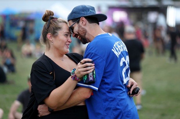 A couple shares a moment at Riot Fest in Chicago's Douglass Park on Friday, Sept. 19, 2025. (Chris Sweda/Chicago Tribune)