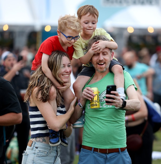 A family makes a portrait while attending Riot Fest in Chicago's Douglass Park on Friday, Sept. 19, 2025. (Chris Sweda/Chicago Tribune)