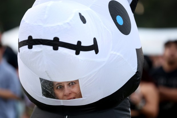 Stephanie Santoro (cq) peers out of her unicorn skeleton blow up while attending Riot Fest in Chicago's Douglass Park on Friday, Sept. 19, 2025. (Chris Sweda/Chicago Tribune)