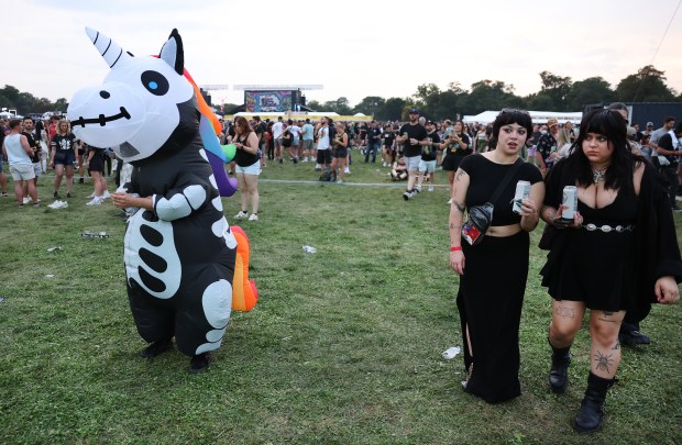 Stephanie Santoro (cq) takes in the scene in her unicorn skeleton blow up while attending Riot Fest in Chicago's Douglass Park on Friday, Sept. 19, 2025. (Chris Sweda/Chicago Tribune)