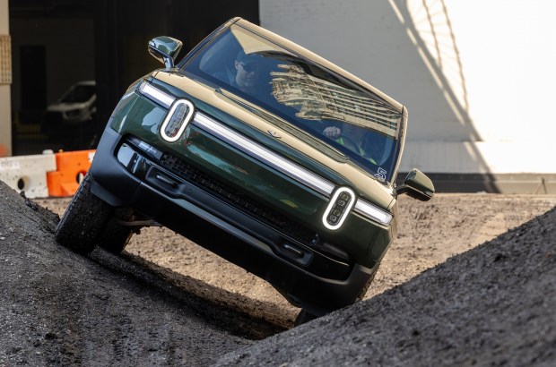 A 2026 Rivian R1S SUV drives on mounds of dirt Sept. 19, 2025, at an off-road course near Pioneer Court in Chicago's Streeterville neighborhood. (Dominic Di Palermo/Chicago Tribune)