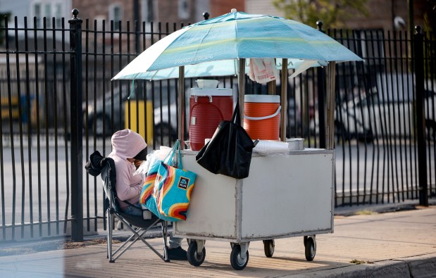 A street vendor in the 2600 block of South Pulaski waits for customers in Chicago's Little Village neighborhood, on Sept. 10, 2025. (Antonio Perez/Chicago Tribune)
