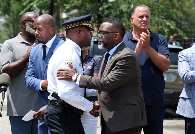 Chicago Police Superintendent Larry Snelling, left, shakes hands with Mayor Brandon Johnson during a press conference at a "Take Back the Block" event in the 1300 block of West 13th Street on July 12, 2024. (Terrence Antonio James/Chicago Tribune)