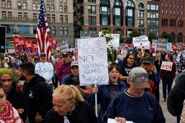 People gather near the Congress Plaza Gardens to protest President Donald Trump's intent to increase immigration enforcement actions in the city and deploy the National Guard, Sept. 6, 2025, in Chicago. (Armando L. Sanchez/Chicago Tribune)