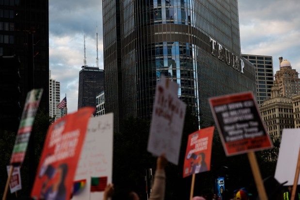 People march past the Trump International Hotel and Tower to protest President Donald Trump's intent to increase immigration enforcement actions in the city and deploy the National Guard, Sept. 6, 2025, in Chicago. (Armando L. Sanchez/Chicago Tribune)