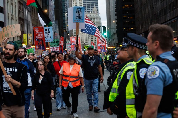 People march along North Michigan Avenue to protest President Donald Trump's intent to increase immigration enforcement actions in the city and deploy the National Guard, Sept. 6, 2025, in Chicago. (Armando L. Sanchez/Chicago Tribune)