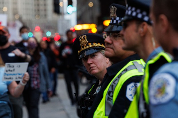 Chicago police stand along North Michigan Avenue as people march to protest President Donald Trump's intent to increase immigration enforcement actions in the city and deploy the National Guard, Sept. 6, 2025, in Chicago. (Armando L. Sanchez/Chicago Tribune)