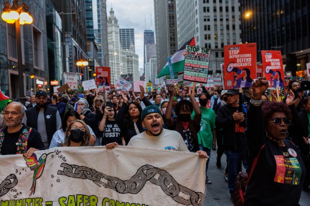 People march along North Michigan Avenue to protest President Donald Trump's intent to increase immigration enforcement actions in the city and deploy the National Guard, Sept. 6, 2025, in Chicago. (Armando L. Sanchez/Chicago Tribune)