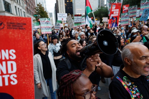 People march along North Michigan Avenue to protest President Donald Trump's intent to increase immigration enforcement actions in the city and deploy the National Guard, Sept. 6, 2025, in Chicago. (Armando L. Sanchez/Chicago Tribune)