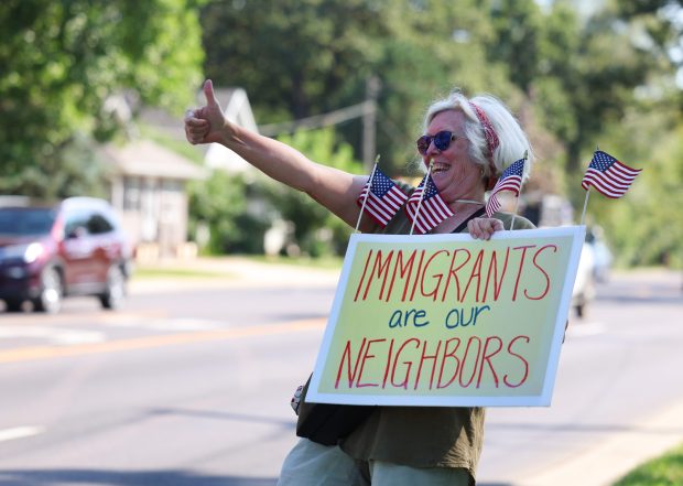 Blair A. Johnson holds a sign in support of immigrants while across the street from the Jel Sert company on Sept. 15, 2025, in West Chicago. Earlier in the day, State Sen. Karina Villa, D-West Chicago, confirmed that Jel Sert would not allow any federal agents onto their property or into their factory without a signed warrant. (Stacey Wescott/Chicago Tribune)
