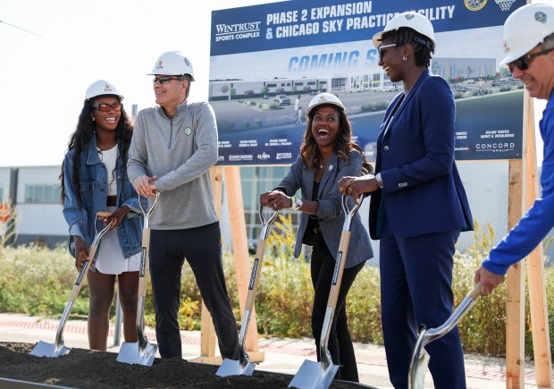 Sky players Michaela Onyenwere, left, and Elizabeth Williams, second from right, stand with principal owner Michael Alter, second from left, co-owner and operating chairman Nadia Rawlinson and owner Harvey Alter to break ground on the team's new training facility in Bedford Park on Oct. 9, 2024. (Eileen T. Meslar/Chicago Tribune)
