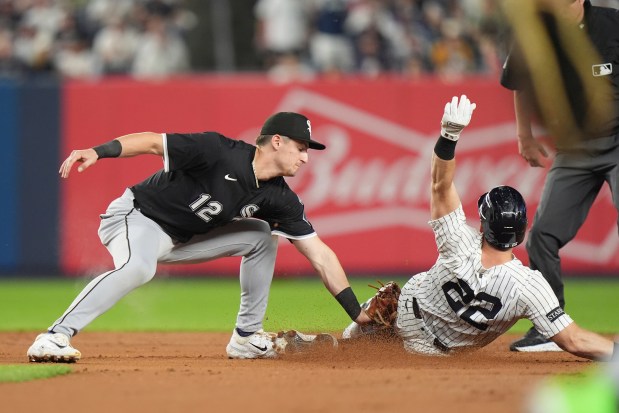 Chicago White Sox's Colson Montgomery (12) tags out New York Yankees' Ben Rice during the fifth inning of a baseball game Tuesday, Sept. 23, 2025, in New York. (AP Photo/Frank Franklin II)