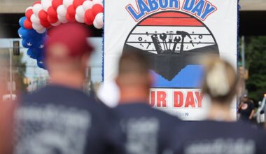 Marchers follow a float up Washington Avenue during the annual Tri-State Labor Day Parade in Philadelphia on Monday.